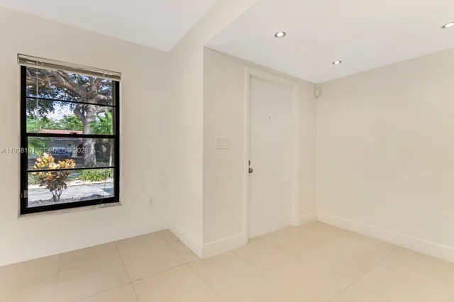 a large kitchen with stainless steel appliances granite countertop a refrigerator and a stove top oven