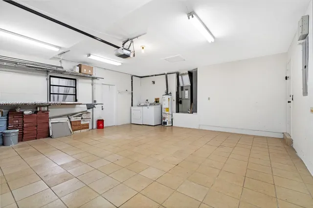 a utility room with cabinets washer and dryer