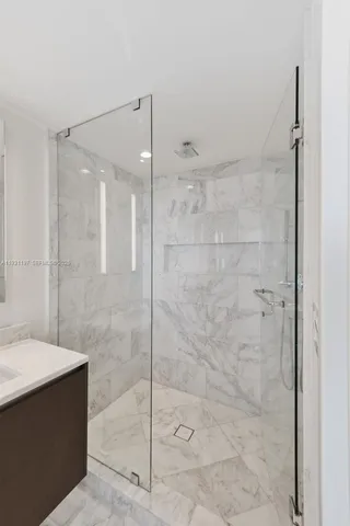 a bathroom with a shower and a sink