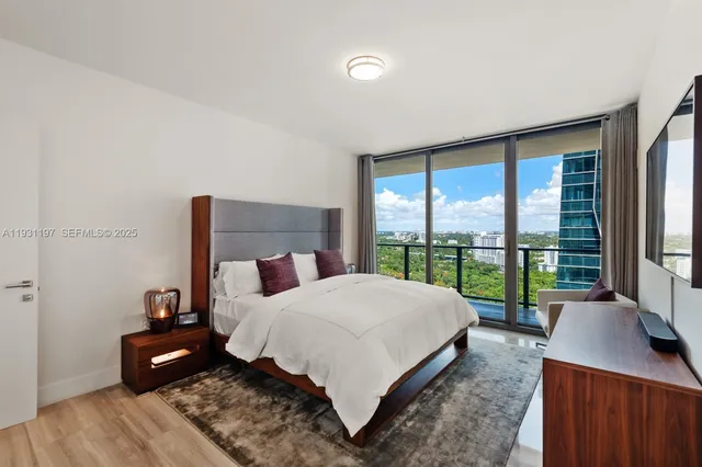 a bedroom with a bed and a night stand