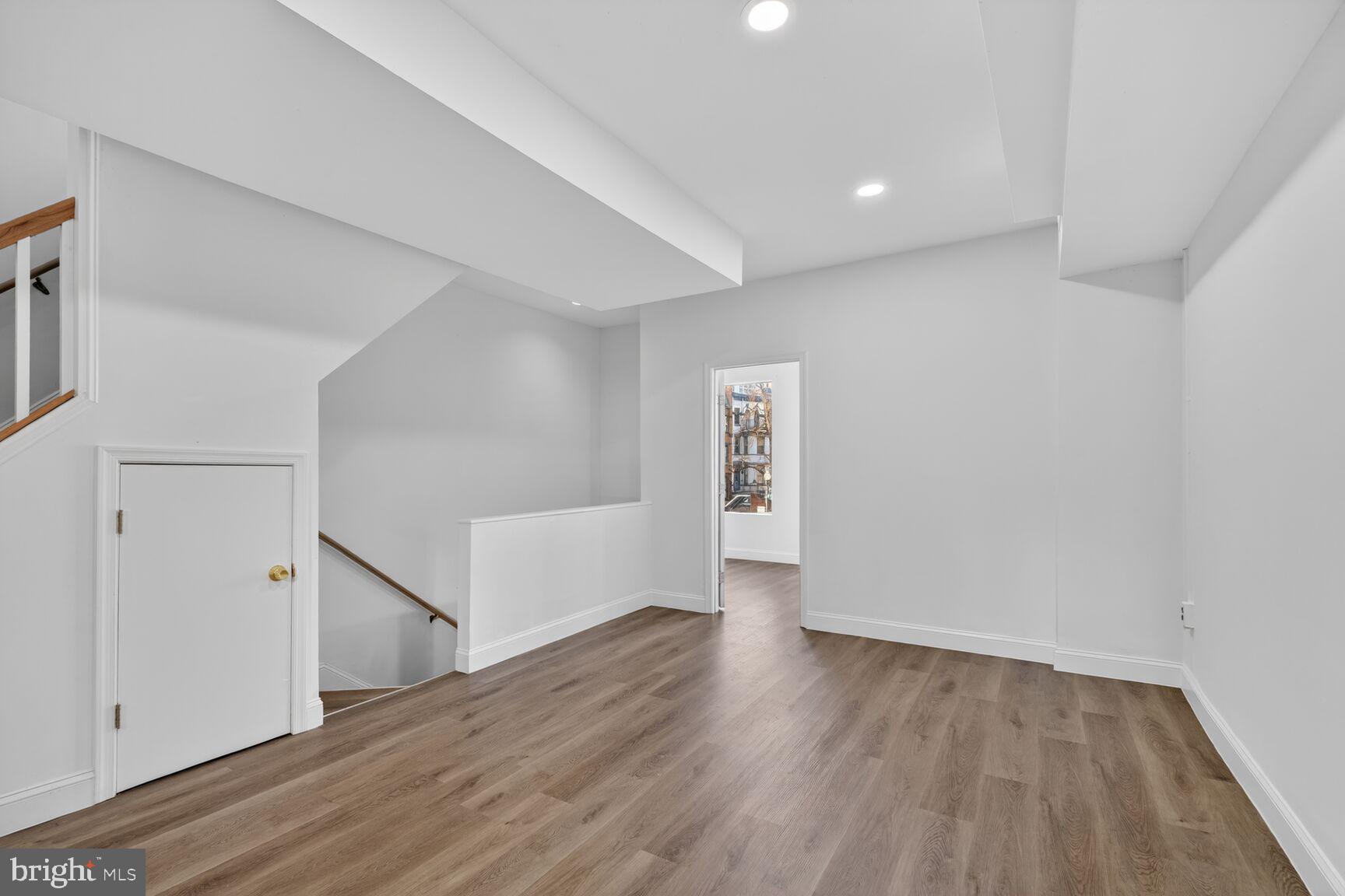 2409 18th Street Northwest, Unit 2 Washington, DC 20009 - Photo 4 of 19 a view of an empty room with wooden floor and a window