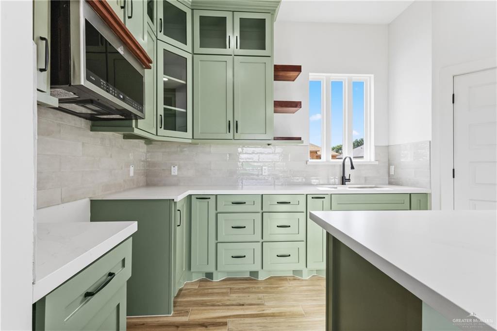 1921 Trinity Street Donna, TX 78537 - Photo 5 of 18 a kitchen with a sink and cabinets