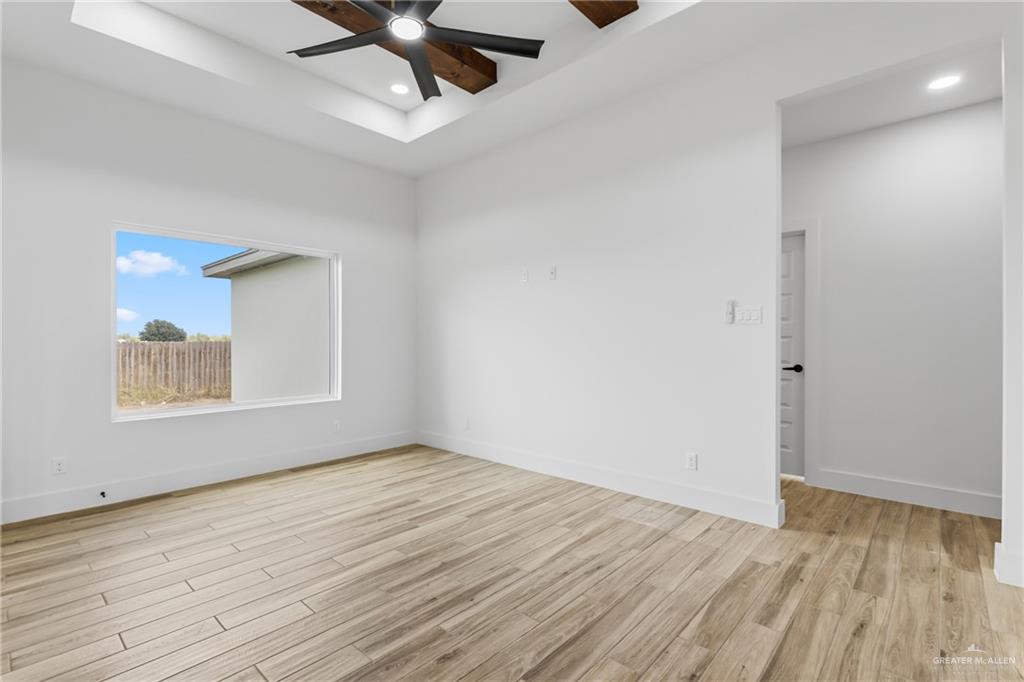 1921 Trinity Street Donna, TX 78537 - Photo 6 of 18 wooden floor in an empty room with a window