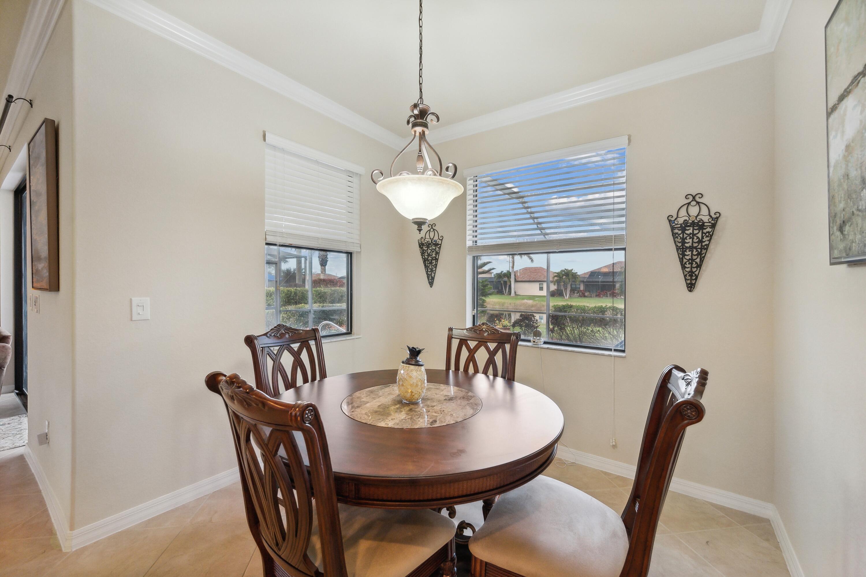 3833 Ruby Way Naples, FL 34114 - Photo 11 of 31 a view of a dining room with furniture window and outside view