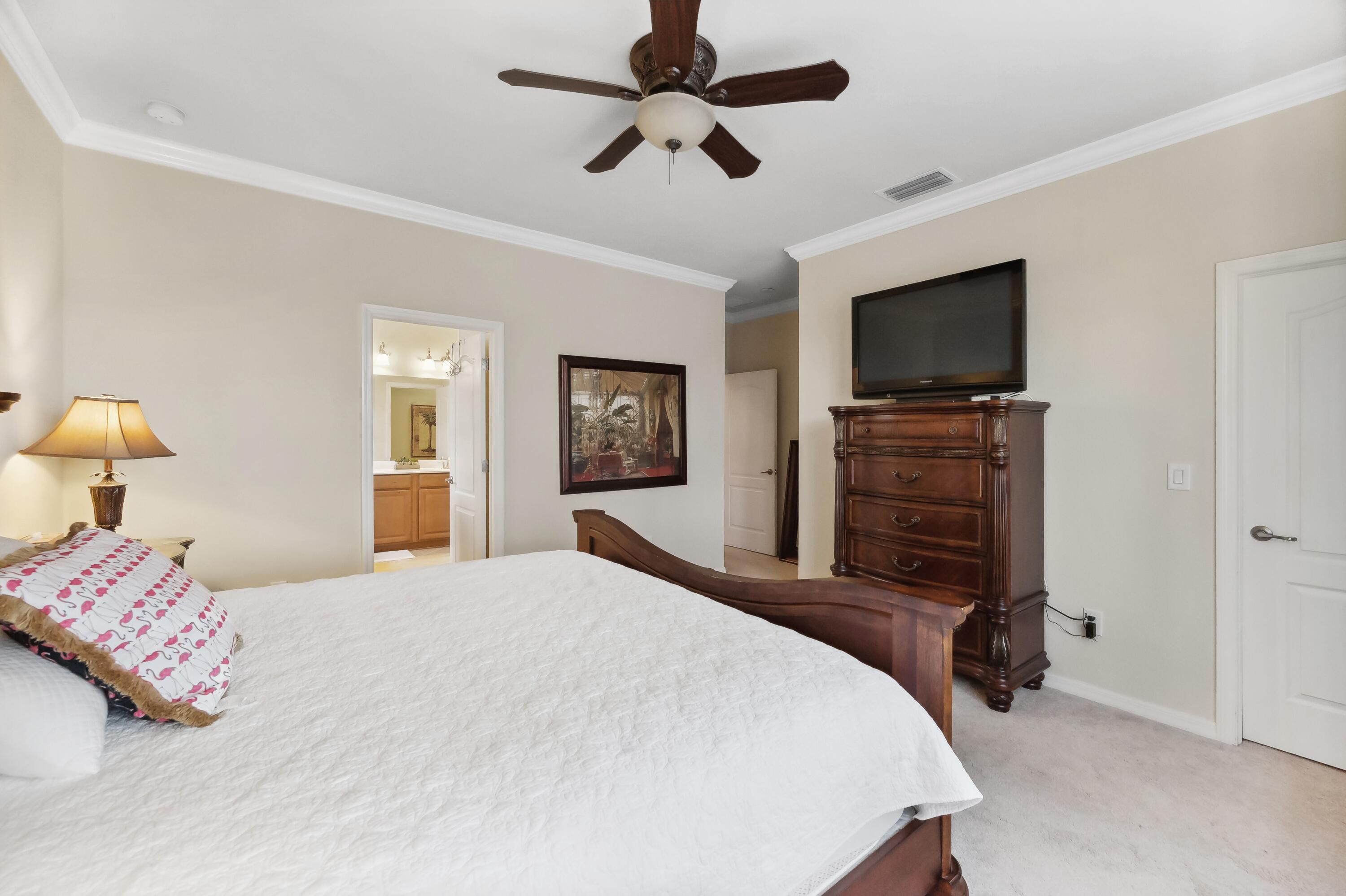 3833 Ruby Way Naples, FL 34114 - Photo 16 of 31 a bedroom with a bed and a flat screen tv