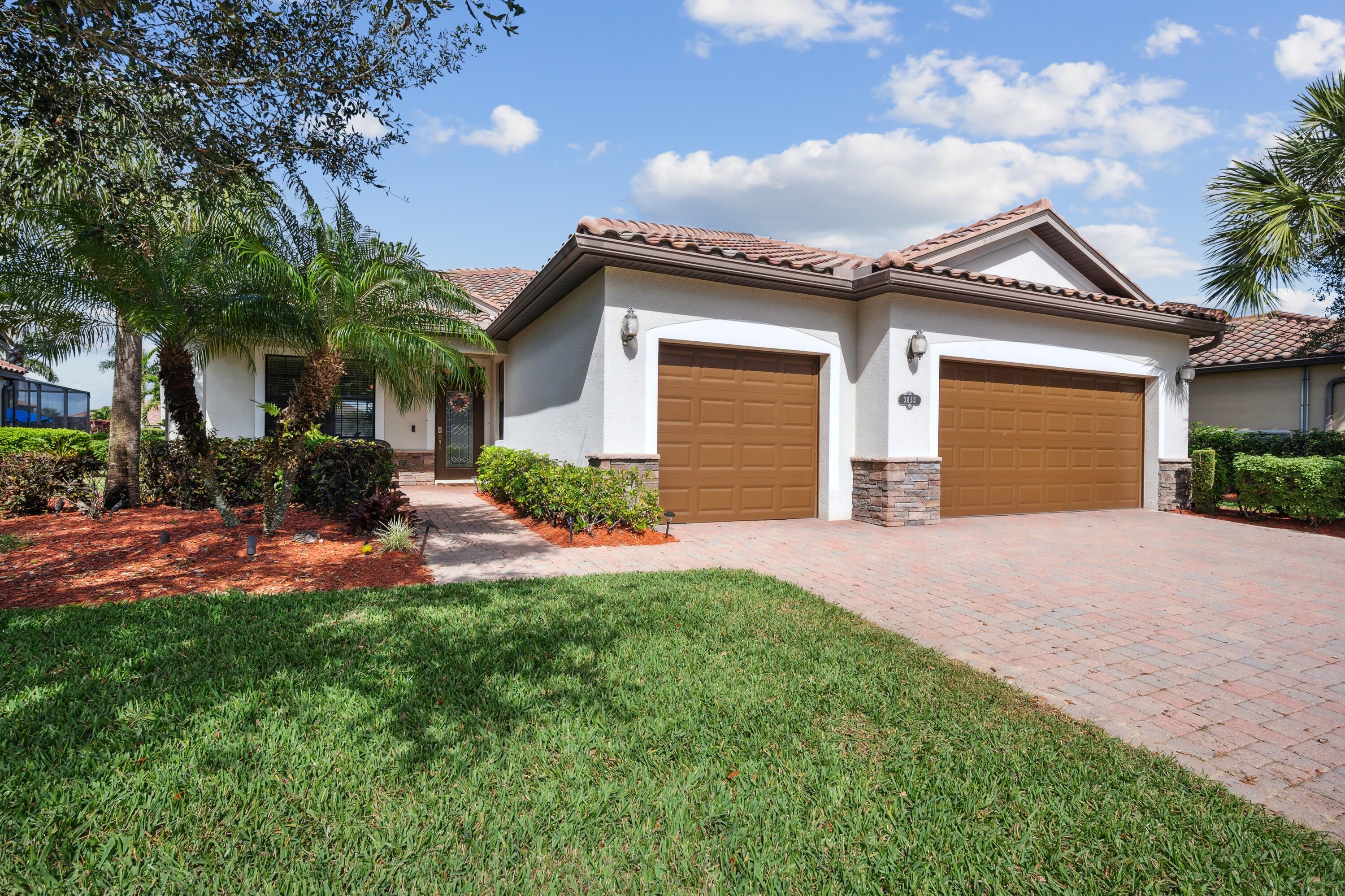 3833 Ruby Way Naples, FL 34114 - Photo 2 of 31 a front view of a house with a yard and garage