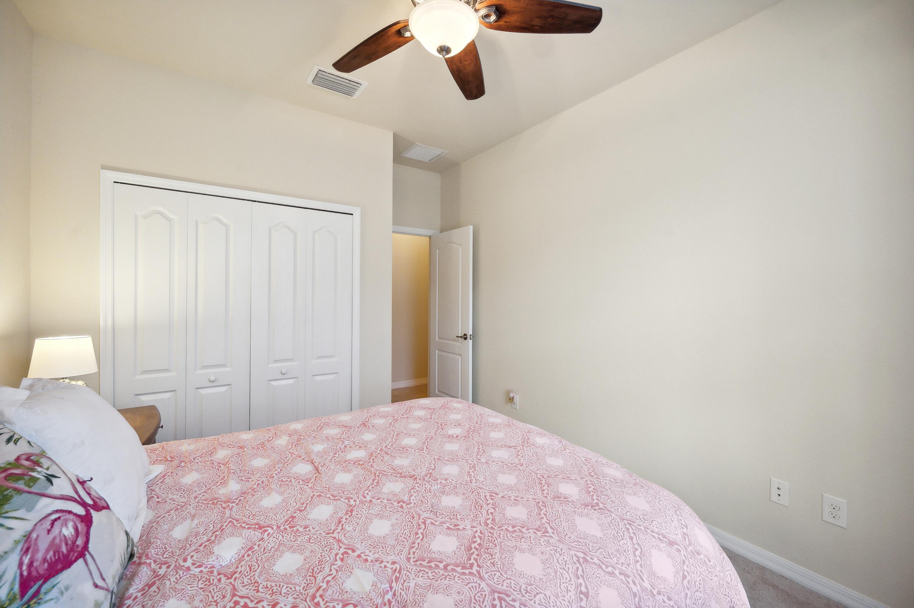 3833 Ruby Way Naples, FL 34114 - Photo 21 of 31 a bedroom with a bed and a chandelier