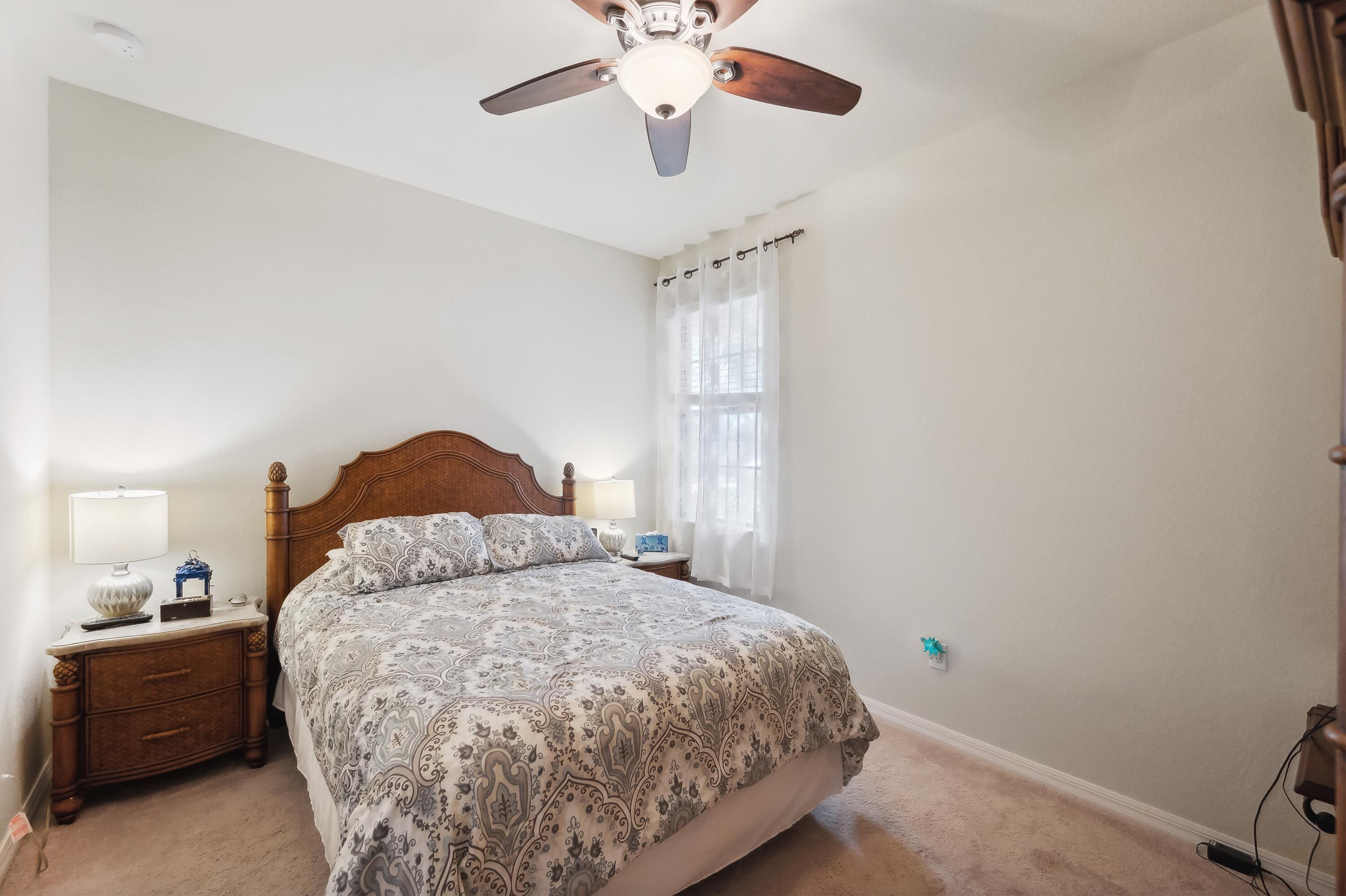 3833 Ruby Way Naples, FL 34114 - Photo 22 of 31 a bedroom with a bed and a chandelier