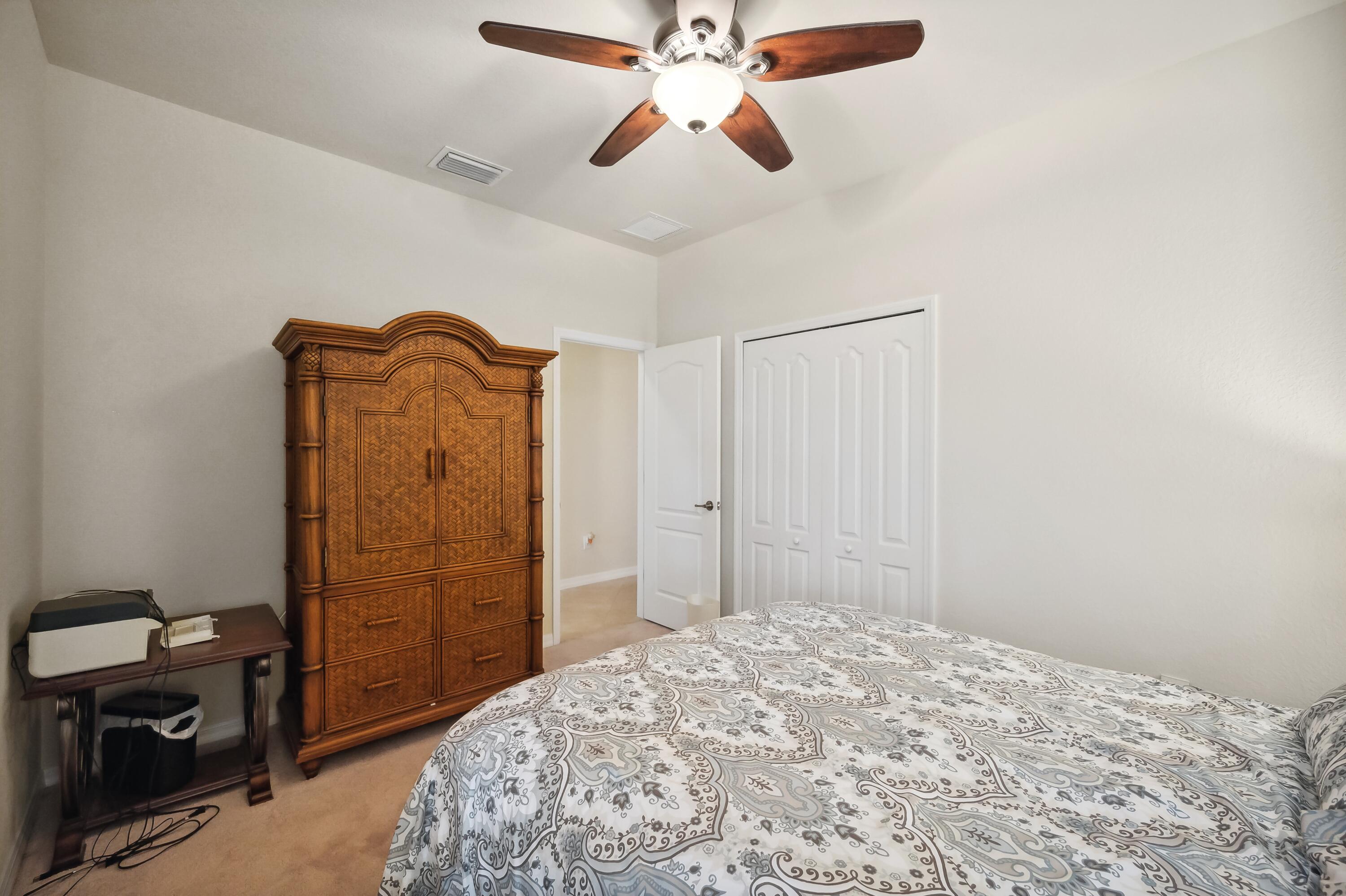 3833 Ruby Way Naples, FL 34114 - Photo 23 of 31 a bedroom with a bed and a dresser