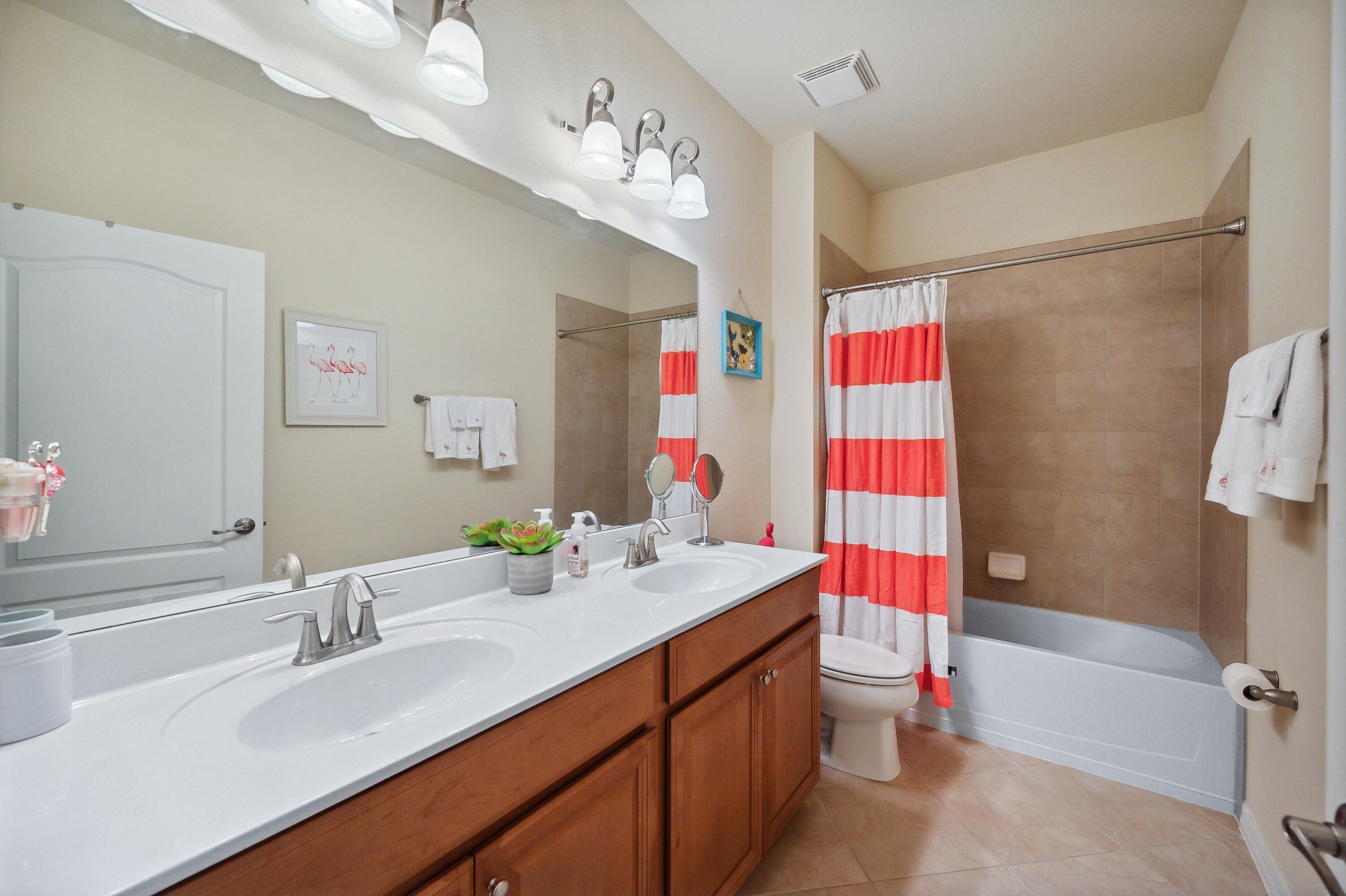 3833 Ruby Way Naples, FL 34114 - Photo 24 of 31 a bathroom with a sink vanity mirror and shower