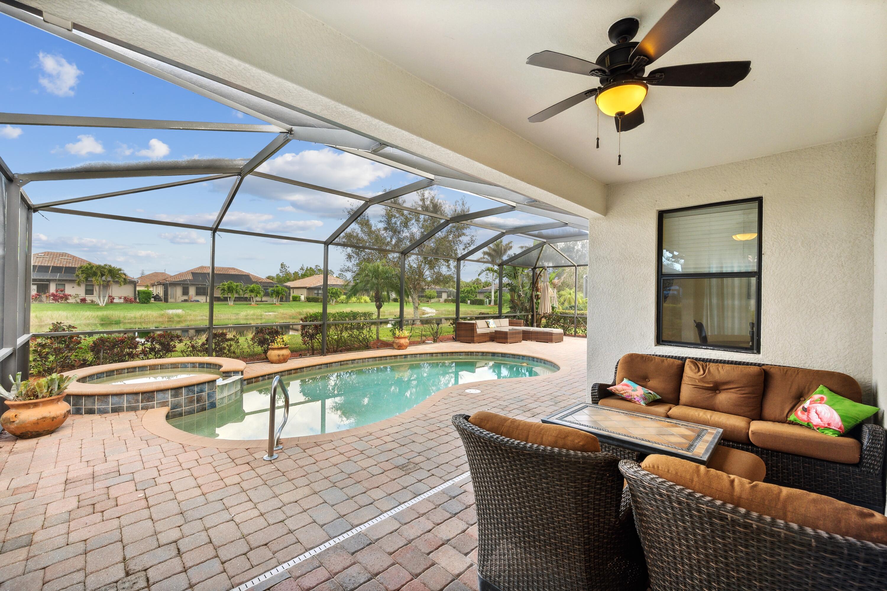 3833 Ruby Way Naples, FL 34114 - Photo 25 of 31 a living room with couch and a floor to ceiling window