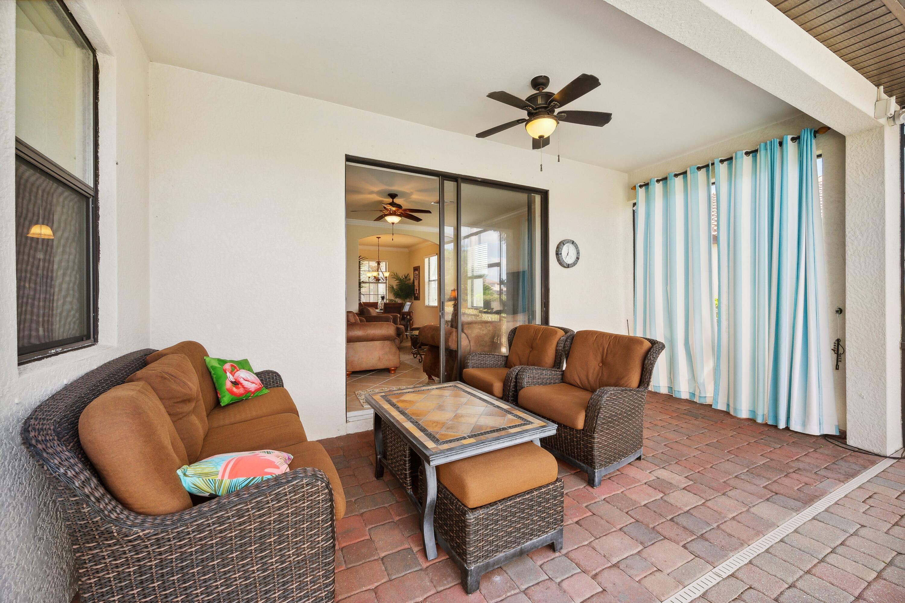 3833 Ruby Way Naples, FL 34114 - Photo 26 of 31 a living room with furniture ceiling fan and a rug