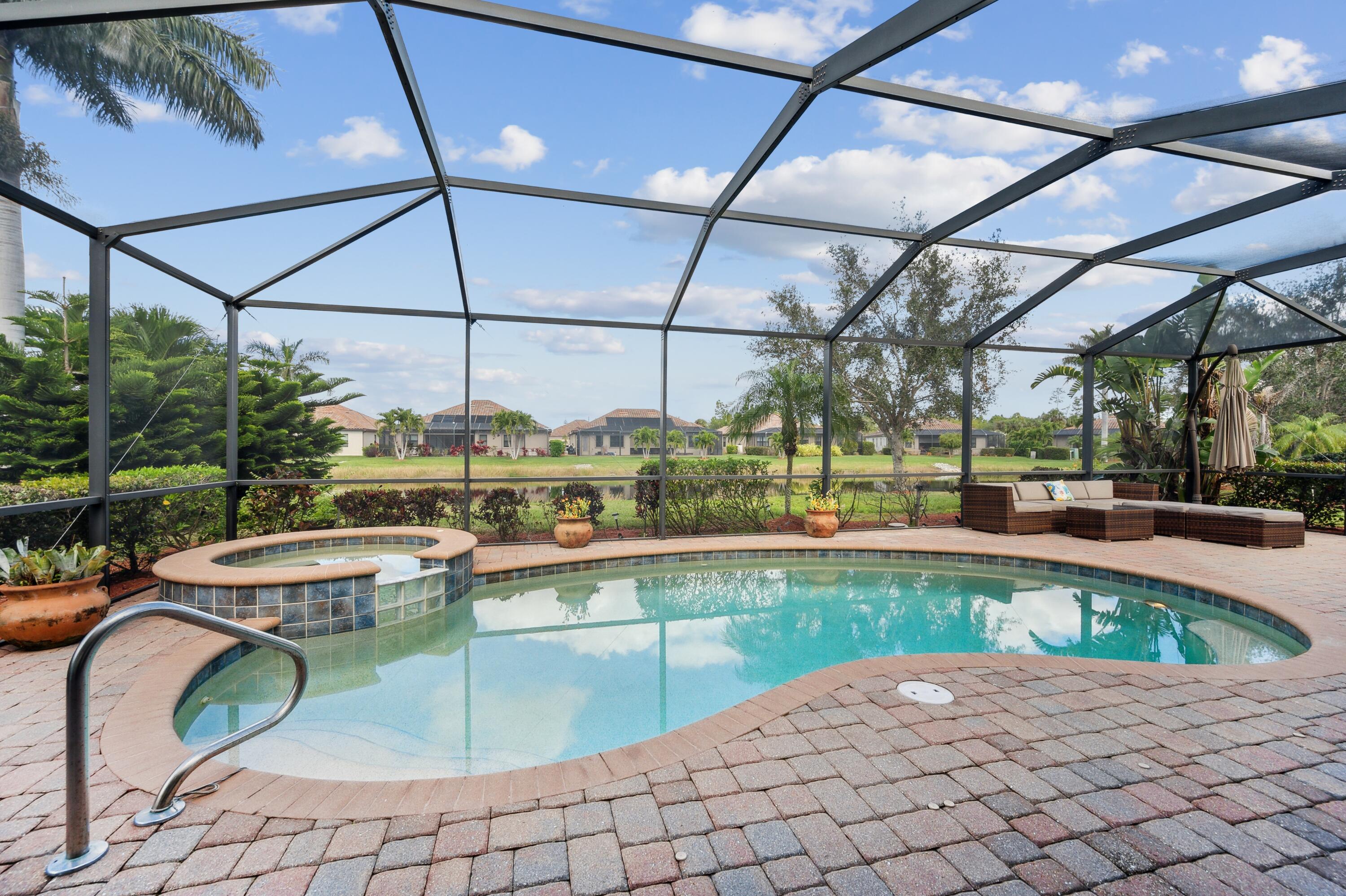 3833 Ruby Way Naples, FL 34114 - Photo 30 of 31 a view of a swimming pool with a patio
