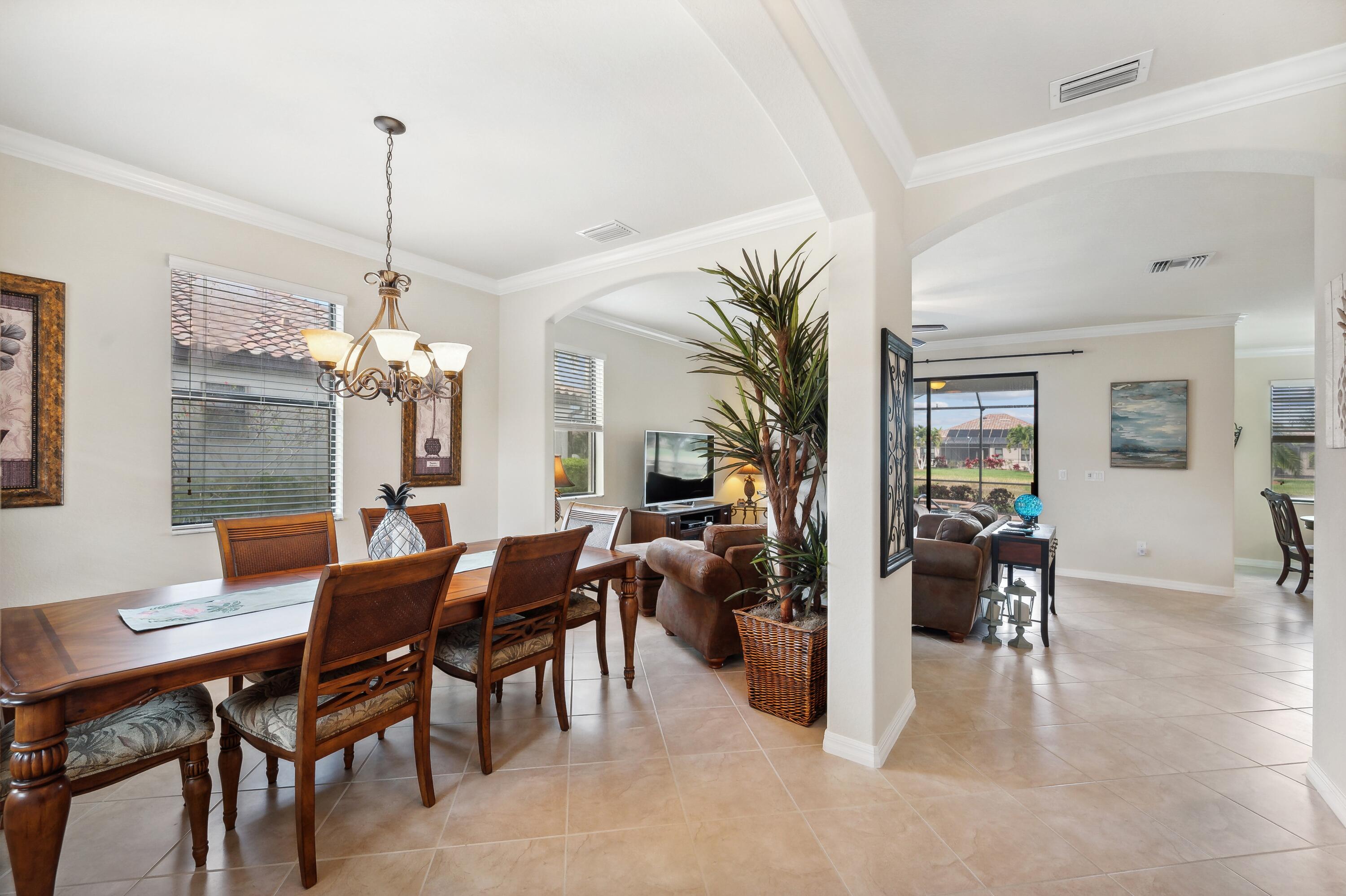 3833 Ruby Way Naples, FL 34114 - Photo 4 of 31 a view of a dining room with furniture window and wooden floor