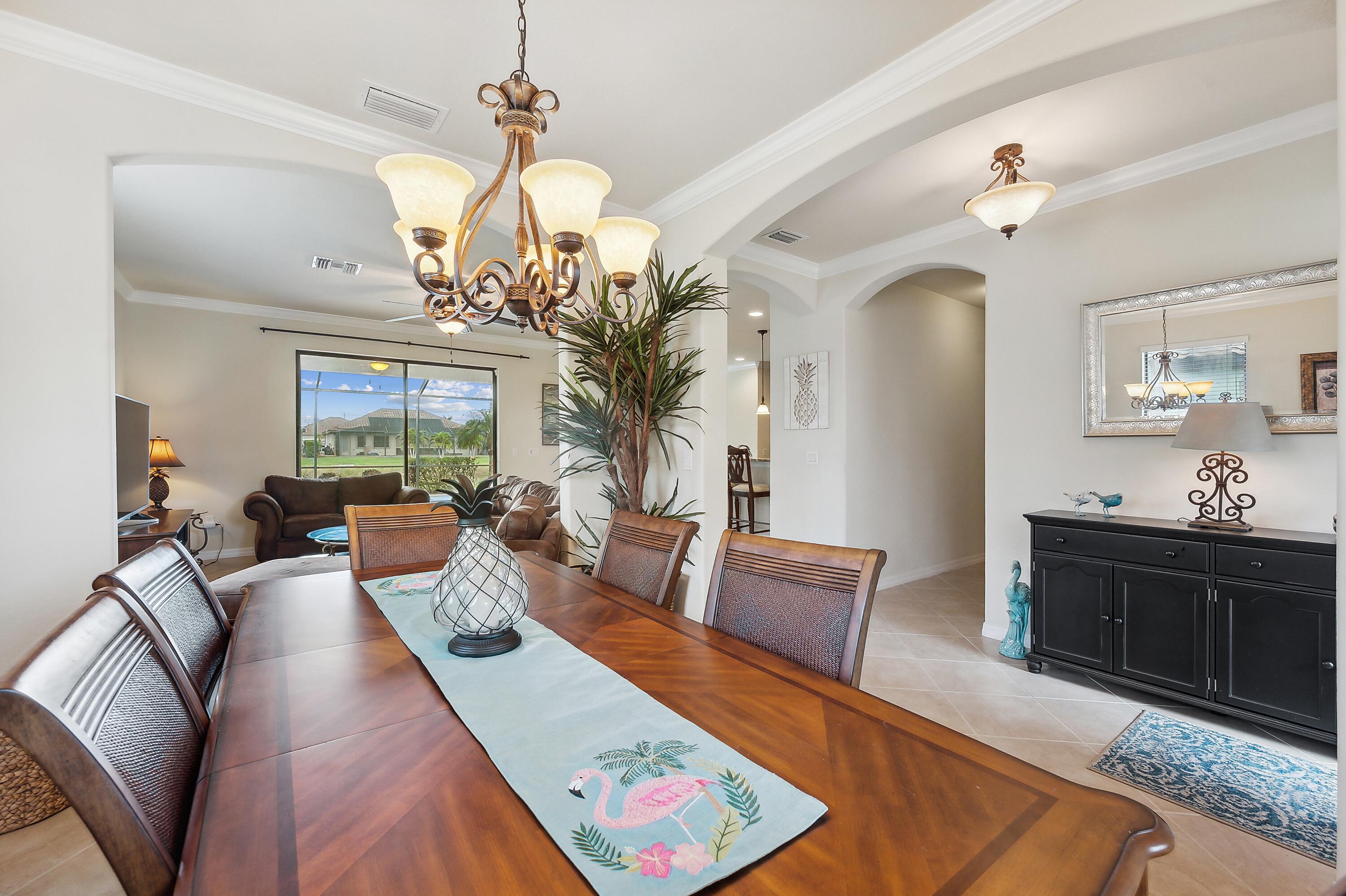 3833 Ruby Way Naples, FL 34114 - Photo 5 of 31 a living room with furniture chandelier and a mirror