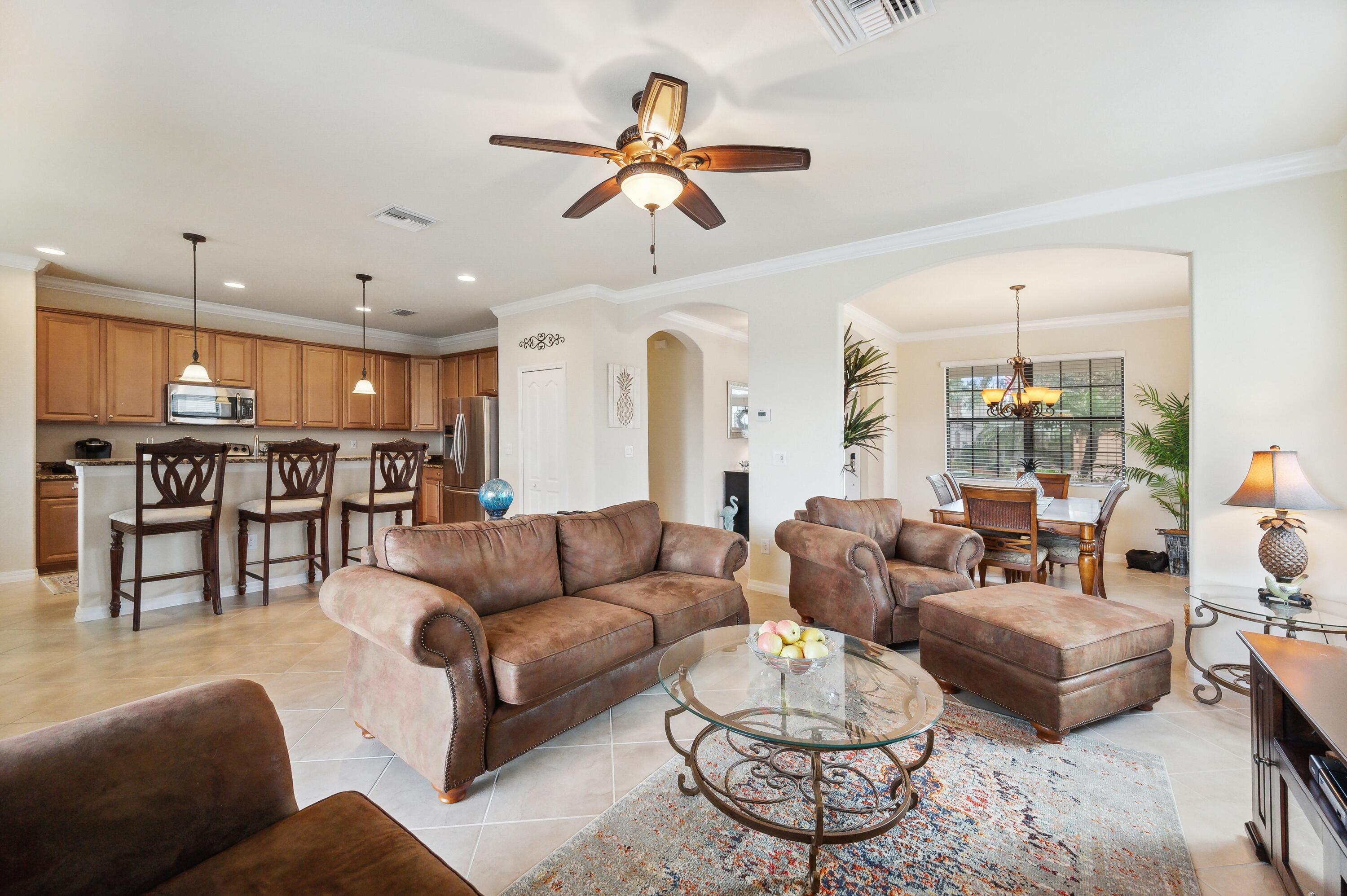 3833 Ruby Way Naples, FL 34114 - Photo 7 of 31 a living room with furniture kitchen view and a chandelier