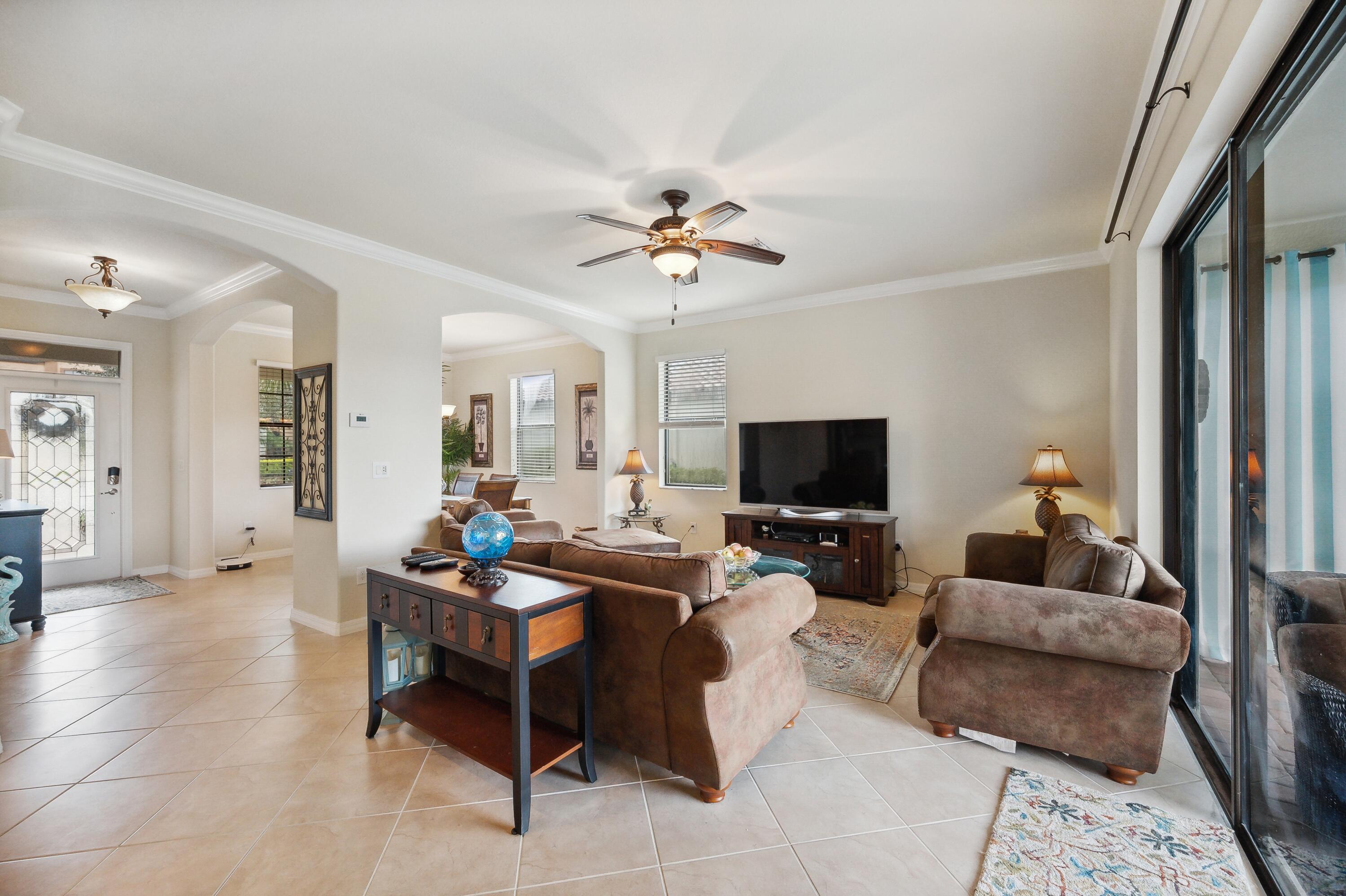 3833 Ruby Way Naples, FL 34114 - Photo 8 of 31 a living room with furniture and a flat screen tv