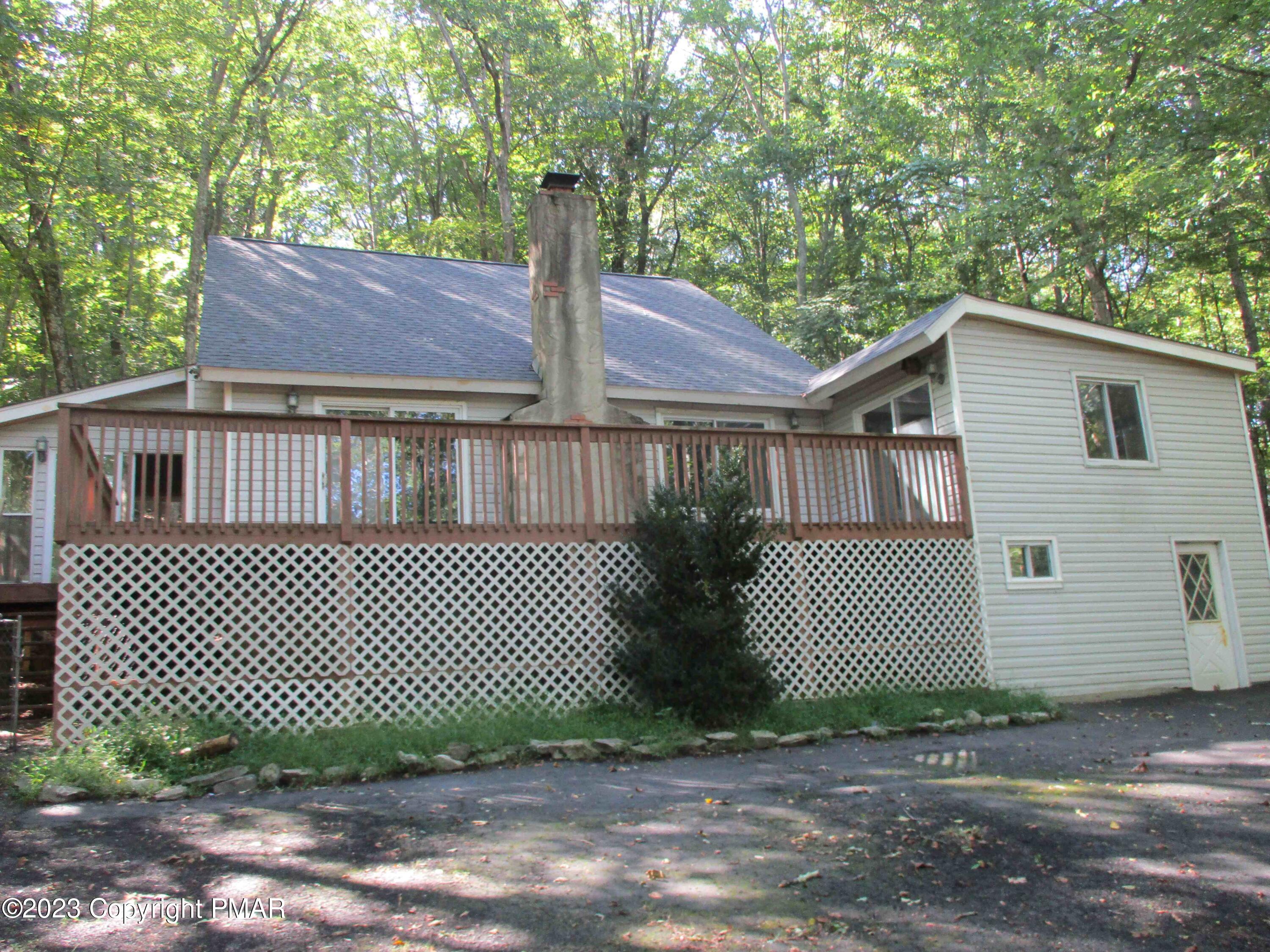 5695 Decker Road Bushkill, PA 18324 - Photo 8 of 9 a front view of a house with a garden