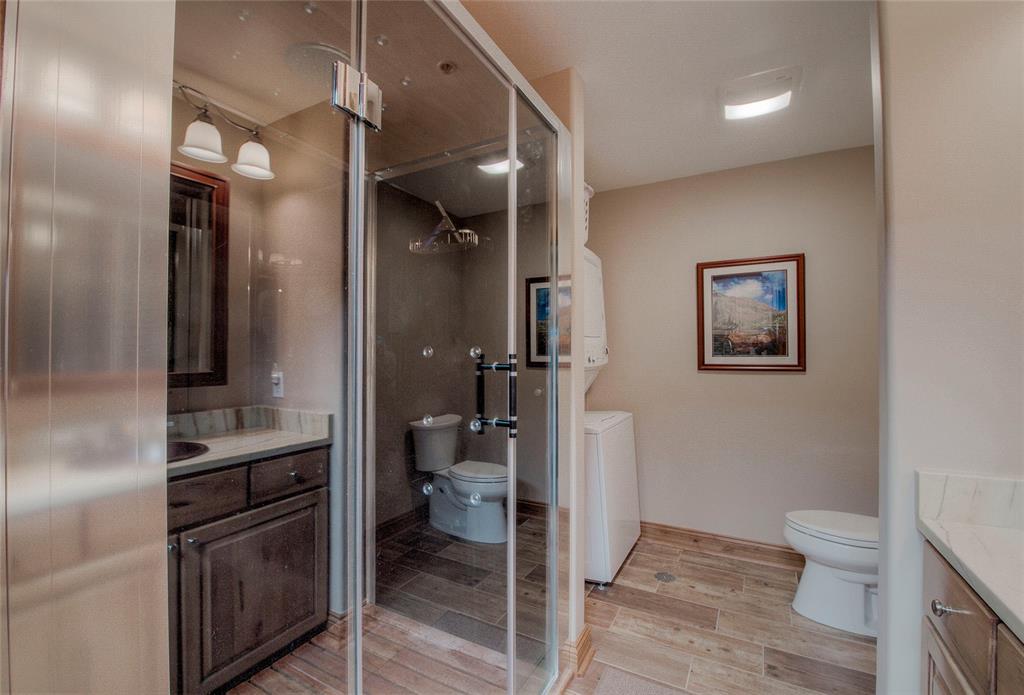 655 4 O Clock Road, Unit 108 Breckenridge, CO 80424 - Photo 14 of 20 a bathroom with a toilet a sink and glass door