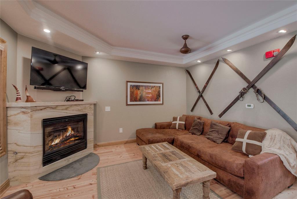 655 4 O Clock Road, Unit 108 Breckenridge, CO 80424 - Photo 4 of 20 a living room with furniture a flat screen tv and a fireplace