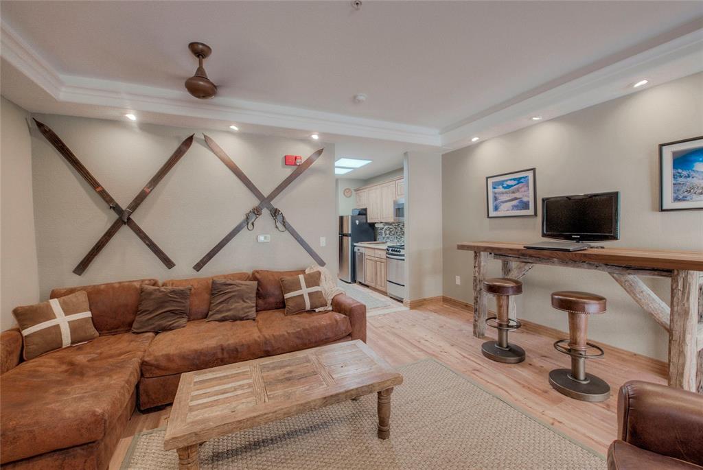 655 4 O Clock Road, Unit 108 Breckenridge, CO 80424 - Photo 7 of 20 a living room with furniture and a flat screen tv