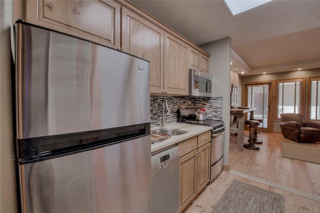 655 4 O Clock Road, Unit 108 Breckenridge, CO 80424 - Photo 10 of 20 a kitchen with stainless steel appliances a refrigerator sink stove and cabinets