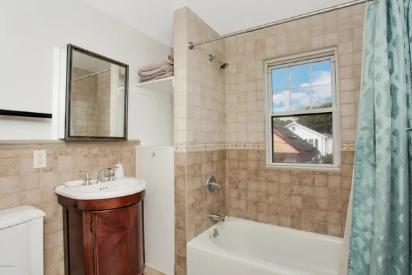 a bathroom with a sink a mirror and a bathtub