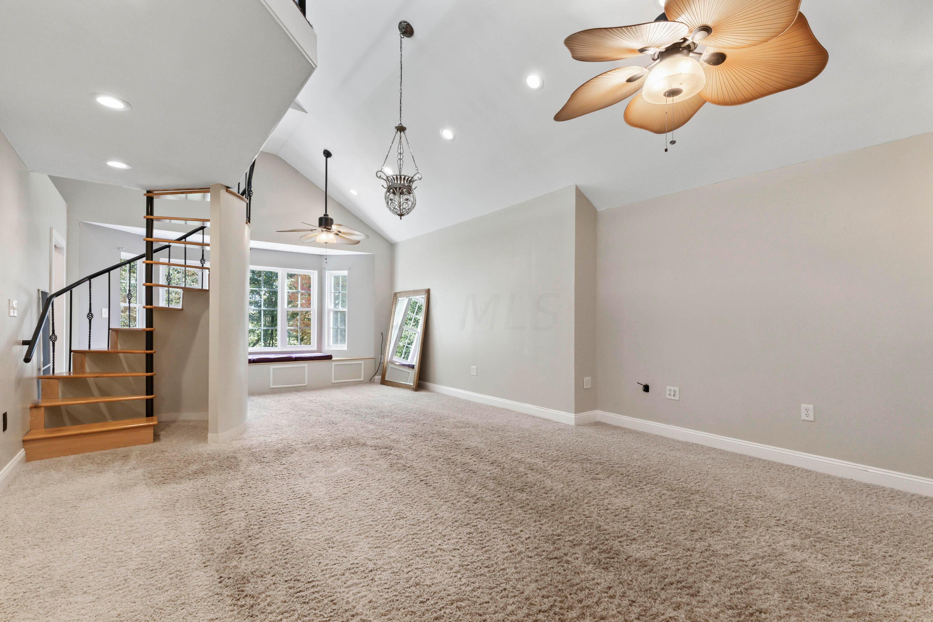 9495 Kilbourne Road Sunbury, OH 43074 - Photo 53 of 84 • Light sand carpet
• Tan painted walls
• (2) lighted ceiling fans
• Window seat
• Vaulted ceiling
• Can lighting
• Hanging lights
• Wet bar with mini refrigerator
& cabinets
• Spiral staircase to Loft