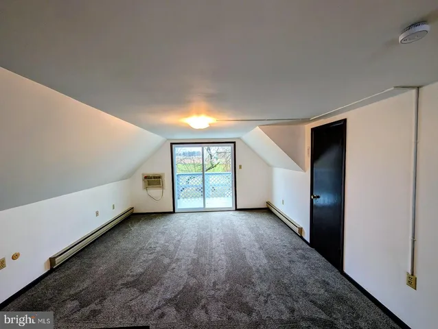 a view of wooden deck with trees in the background