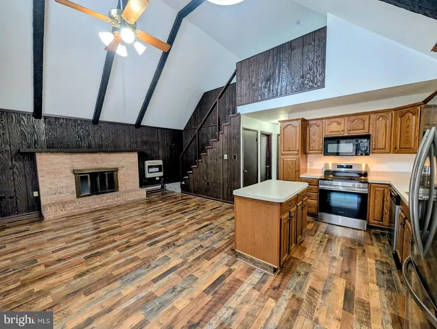 a kitchen with a sink appliances and cabinets