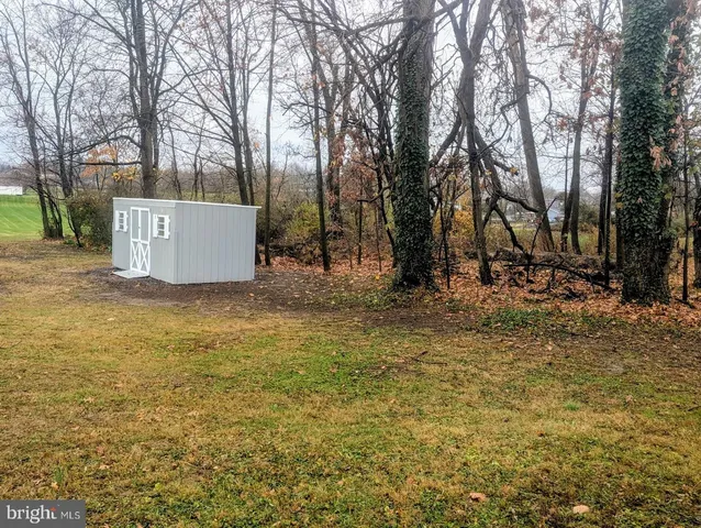 a view of a house with snow on the background