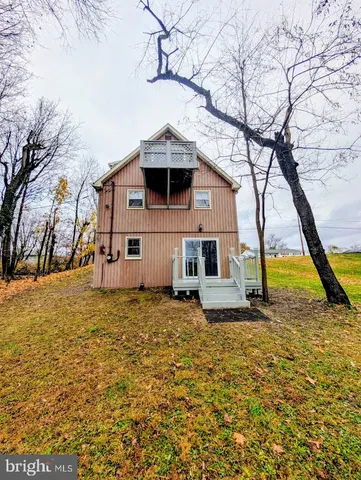 a house that has a tree in front of it