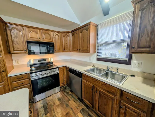 a kitchen with stainless steel appliances a stove sink and microwave