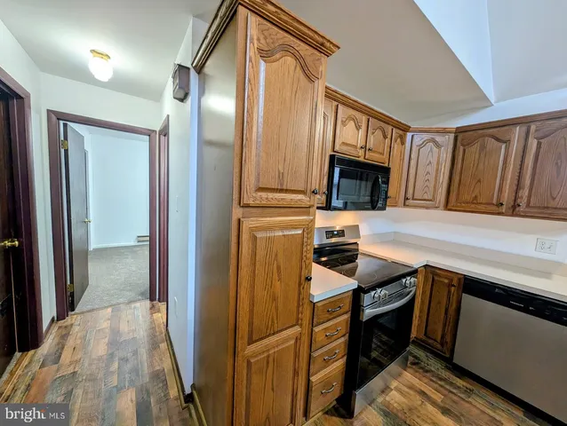 a kitchen with a refrigerator and a stove top oven