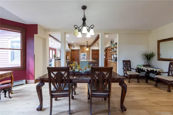 a view of a patio with table and chairs with wooden floor and fence
