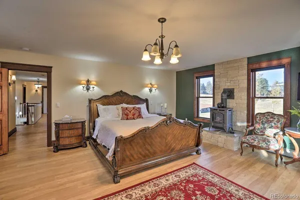 a living room with furniture a large window and a fireplace
