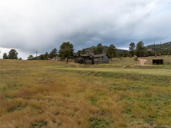 a view of a backyard with wooden fence