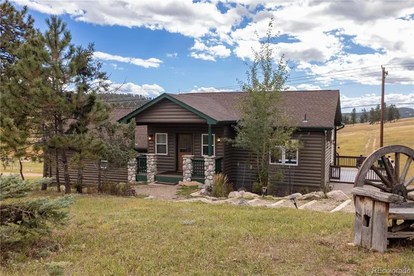 a large kitchen with kitchen island a sink a stove a refrigerator and white cabinets with wooden floor