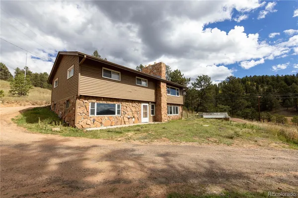 a view of a house with a mountain in the background