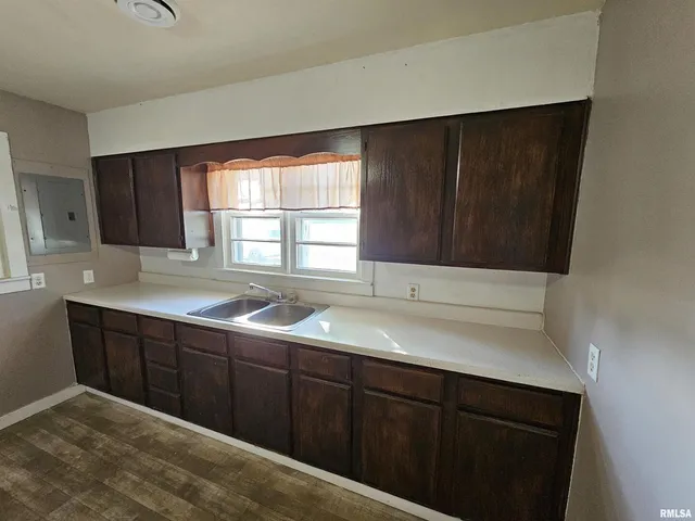 a kitchen with a sink and cabinets
