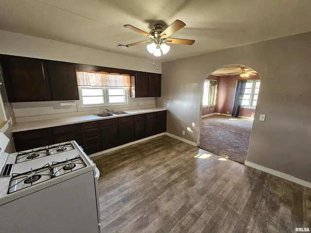 a kitchen with a stove a sink and a refrigerator