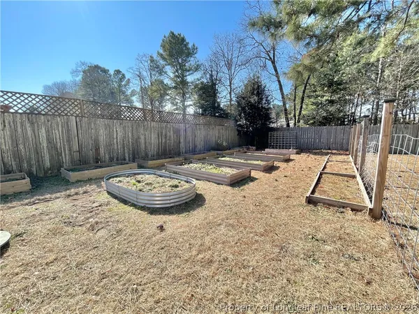 a view of swimming pool with a backyard and wooden fence