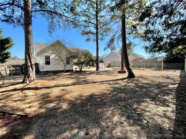 a view of a house with a yard covered with snow