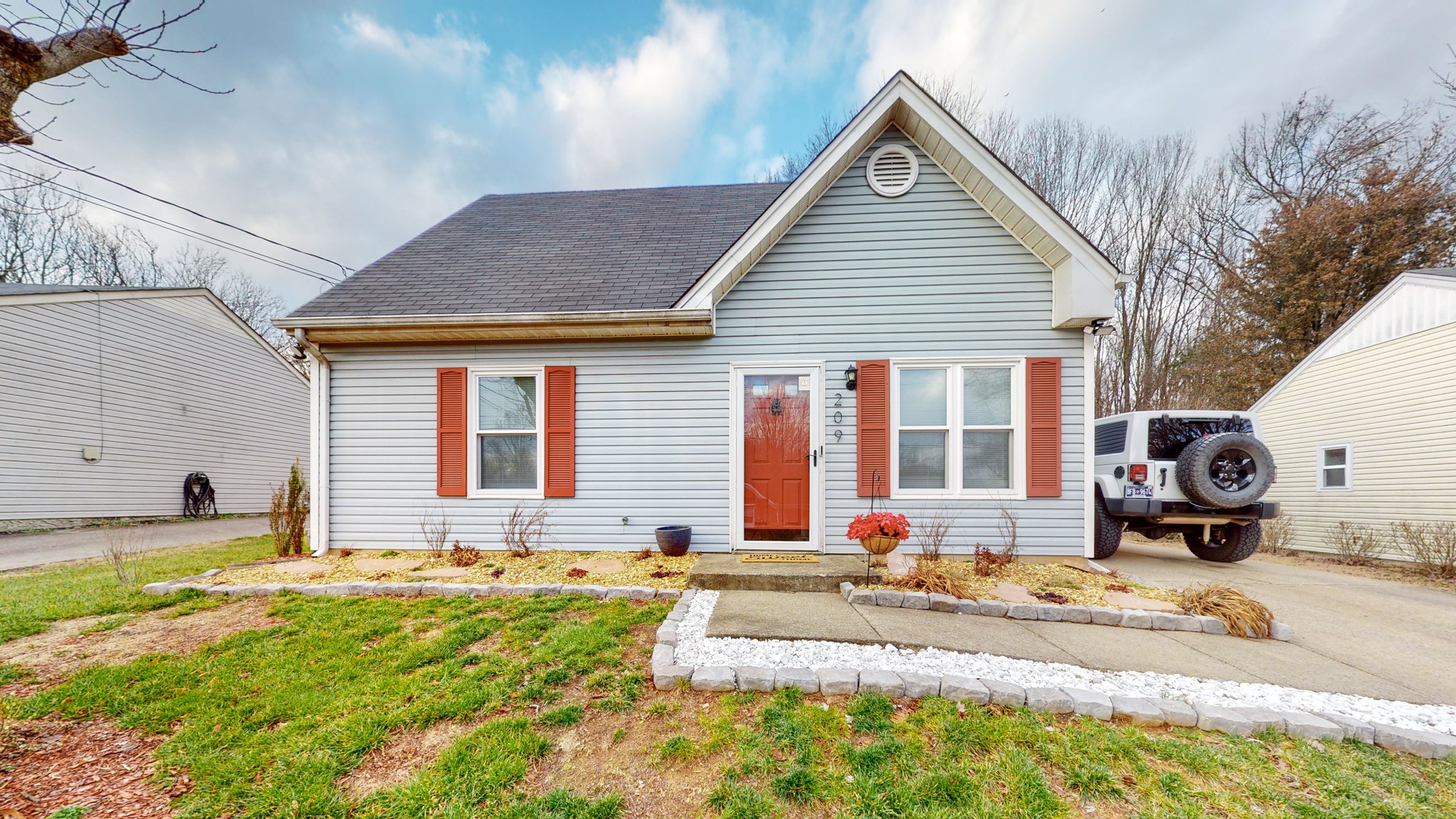 a front view of house with yard and outdoor seating