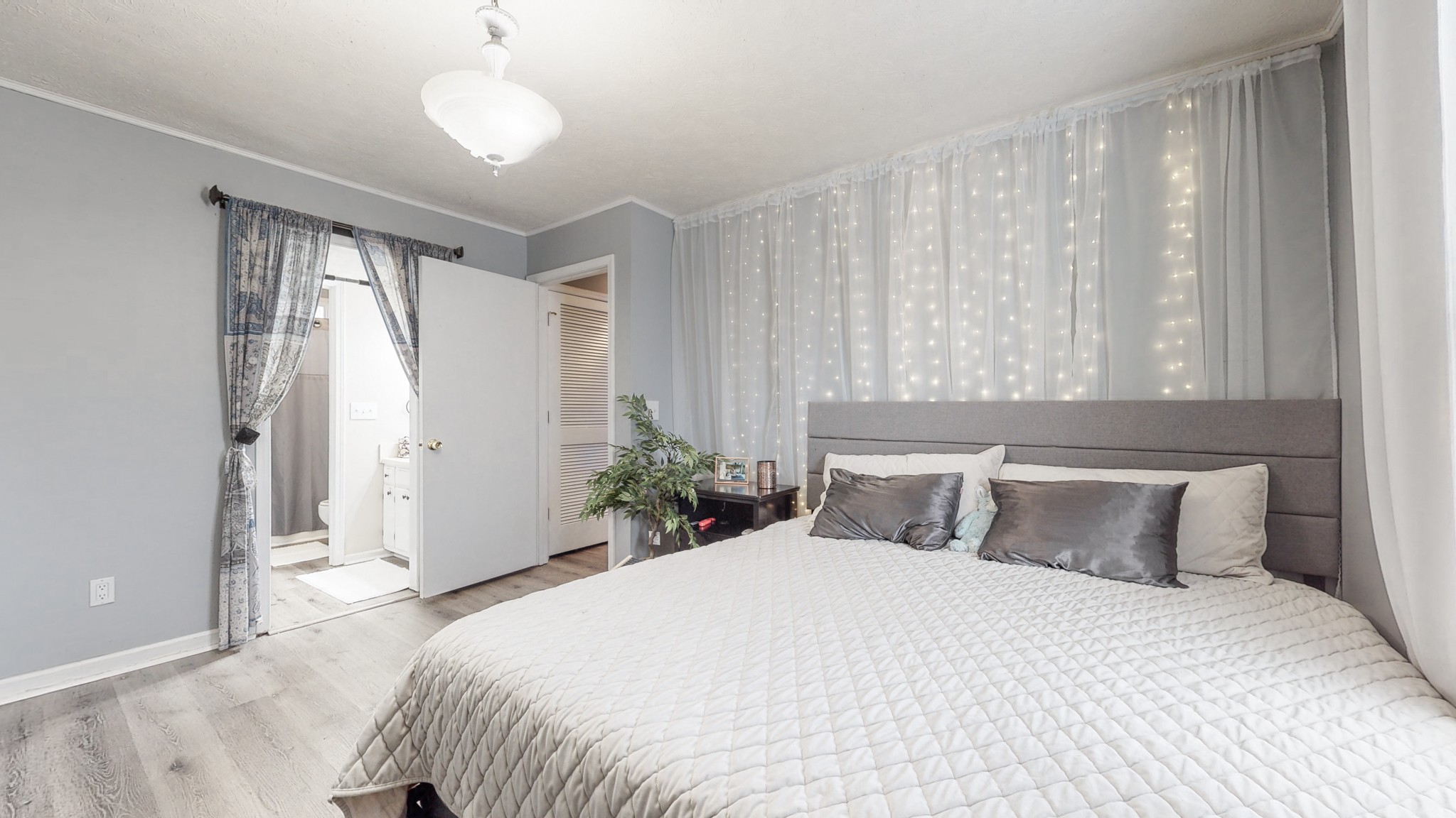 209 Dockside Court Hermitage, TN 37076 - Photo 12 of 43 a bedroom with a large bed and a chandelier