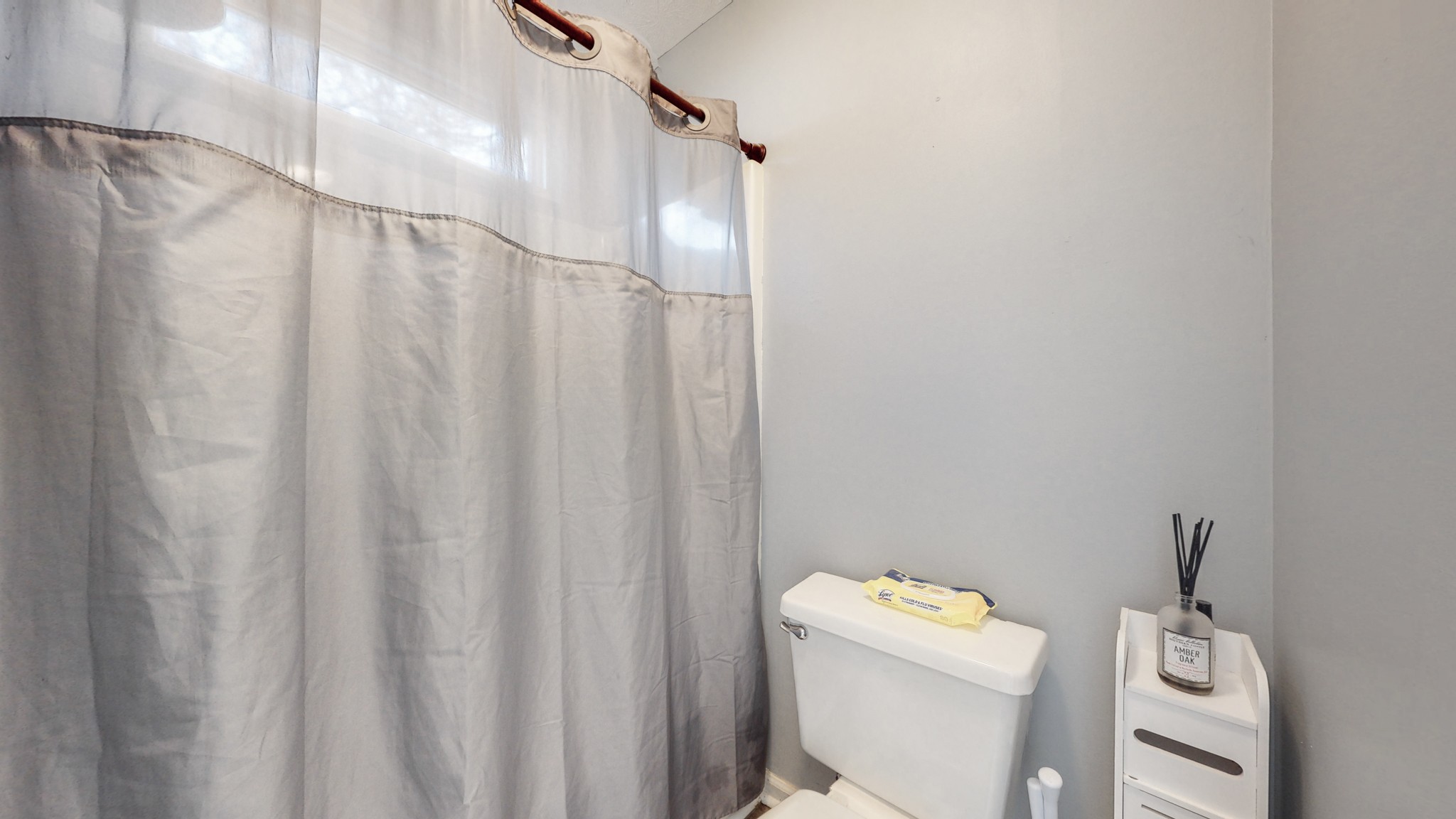 209 Dockside Court Hermitage, TN 37076 - Photo 14 of 43 a bathroom with a toilet and shower curtain