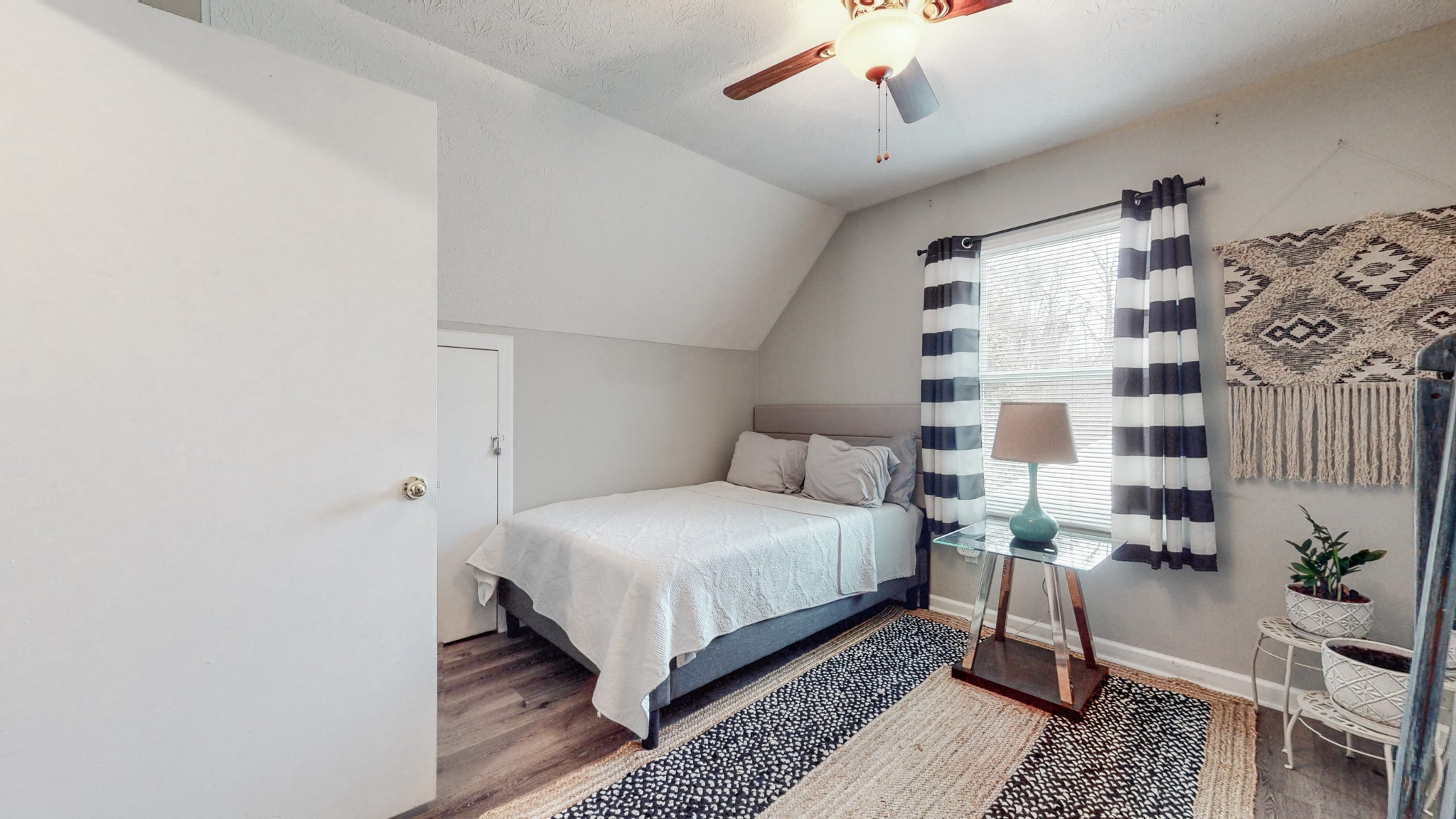 209 Dockside Court Hermitage, TN 37076 - Photo 21 of 43 a bedroom with a bed lamp and a potted plant