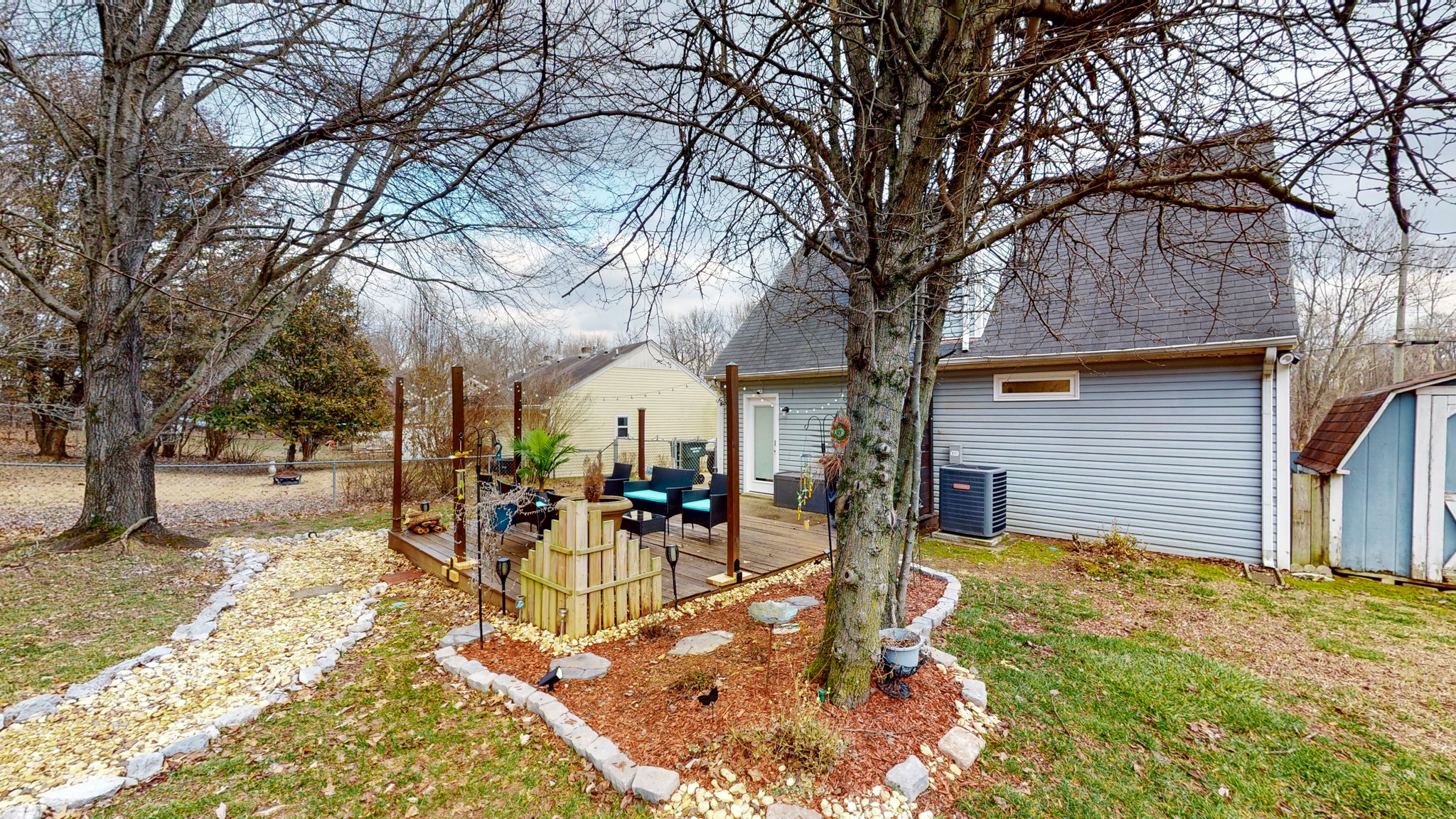 209 Dockside Court Hermitage, TN 37076 - Photo 29 of 43 a view of a backyard with table and chairs under a large tree