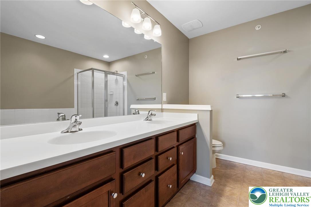 8455 Starling Road Breinigsville, PA 18031 - Photo 14 of 24 Double vanity and a spacious shower create a highly functional primary bathroom.