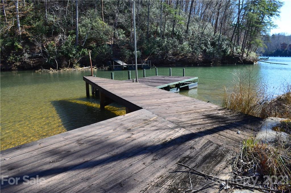 999 Parkway North Rd Mill Spring Mill Spring, NC 28756 - Photo 4 of 33 a view of a lake with a bench and trees